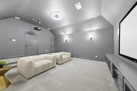 a spacious bedroom with a bed and a night stand