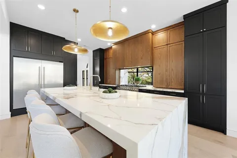 a dining table with chairs and cabinets