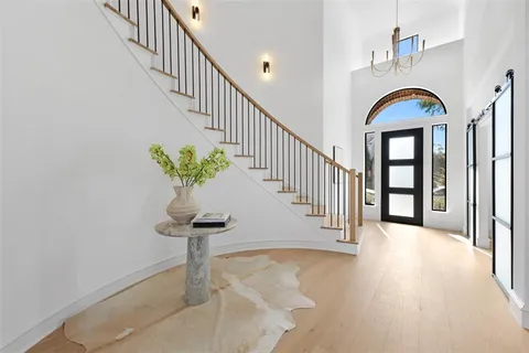 a view of staircase with wooden floor and a potted plant