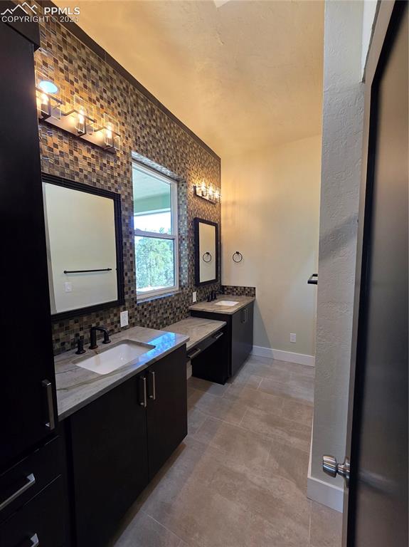 33036 Meadow Ridge Lane Trinidad, CO 81082 - Photo 35 of 50 Bathroom with ornamental molding, vanity, and tasteful backsplash