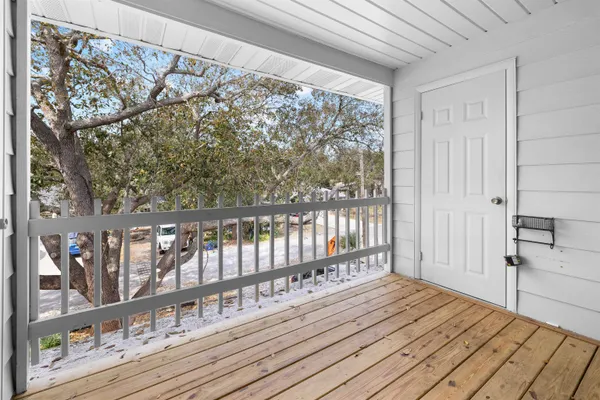 a view of a balcony with wooden floor