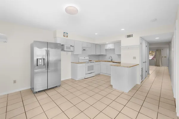 a kitchen with stainless steel appliances a refrigerator sink and cabinets