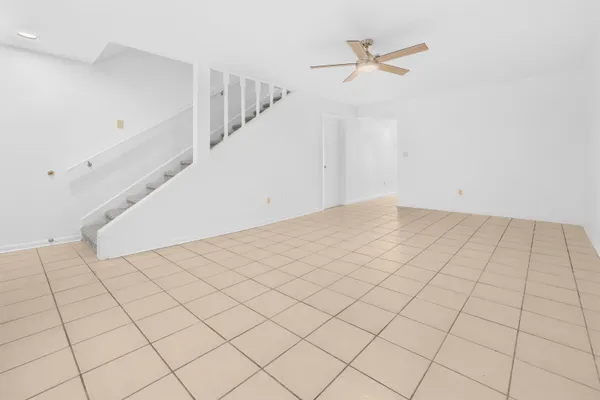 a view of a livingroom with white walls and entryway