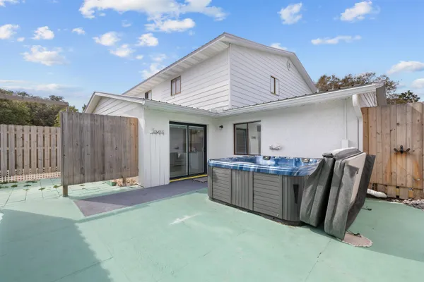 a view of a patio with wooden fence