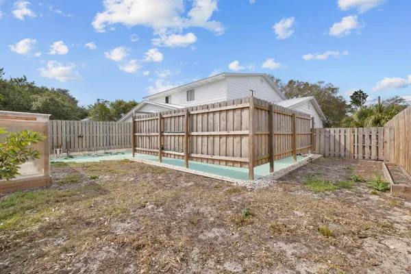 a view of a backyard with wooden fence