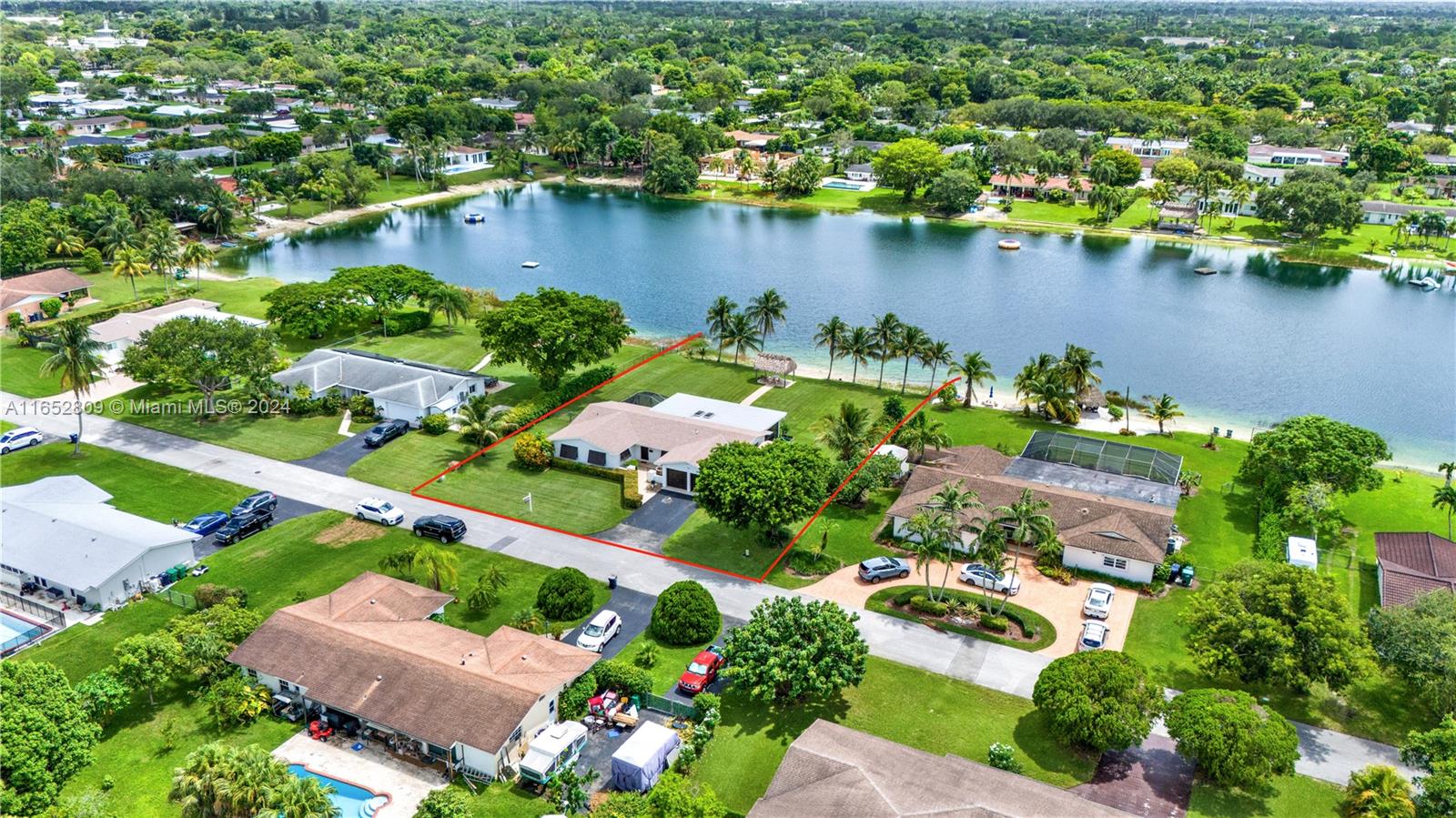 an aerial view of a house with a yard and lake view