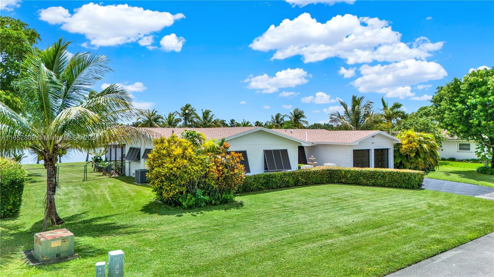 10962 Southwest 117th Street Miami, FL 33176 - Photo 13 of 42 a view of a house with a big yard and potted plants