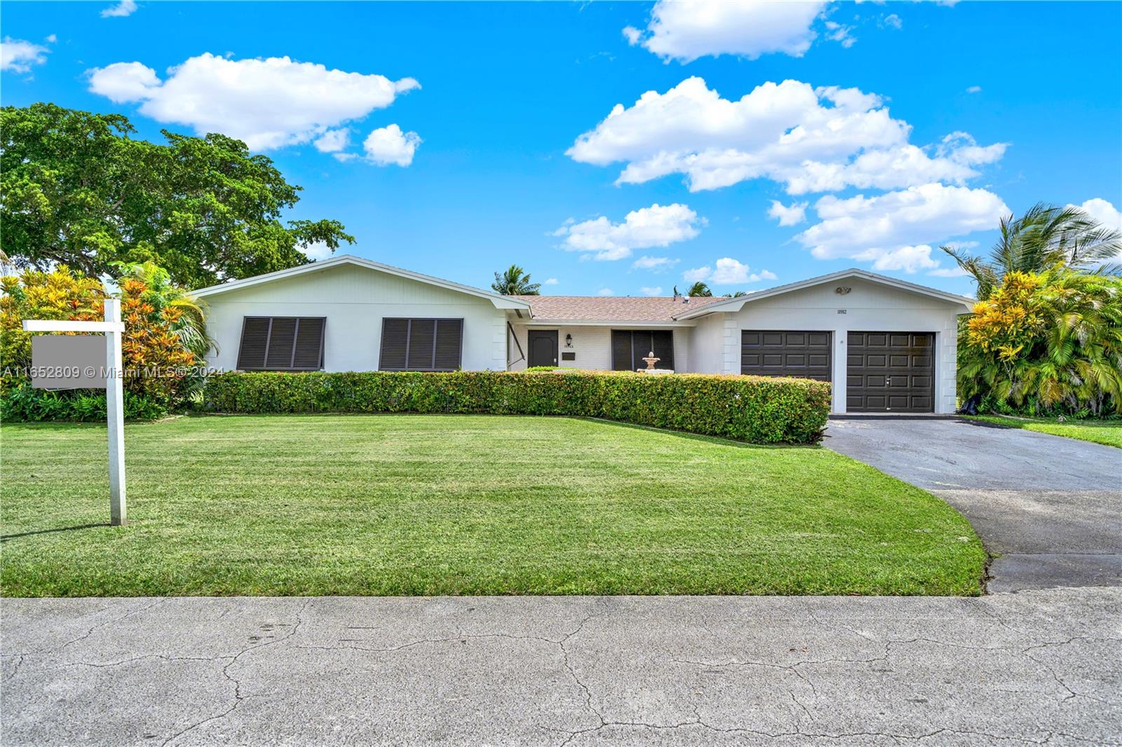 10962 Southwest 117th Street Miami, FL 33176 - Photo 14 of 42 a front view of a house with a garden