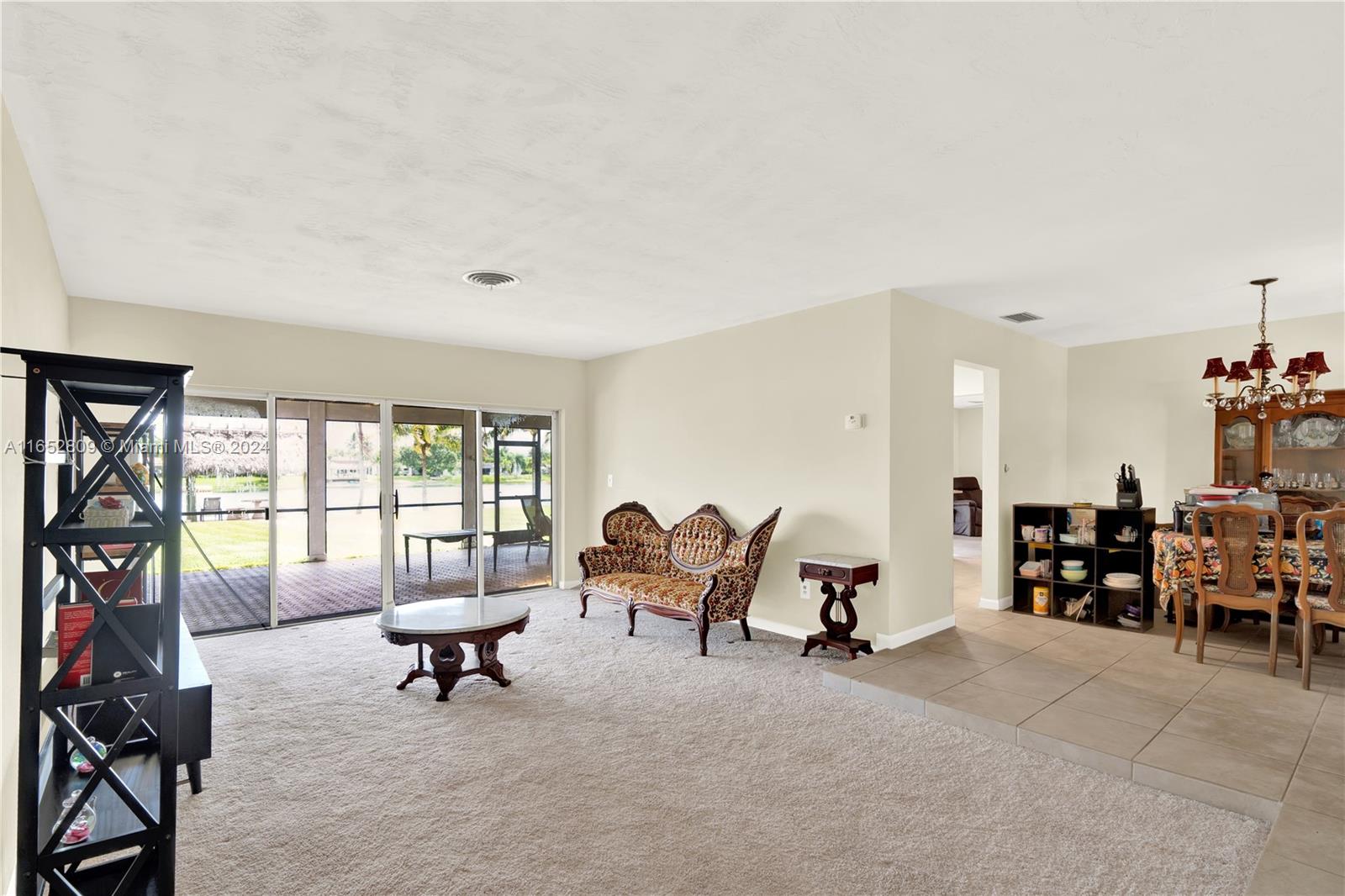 10962 Southwest 117th Street Miami, FL 33176 - Photo 20 of 42 a living room with furniture a fireplace and large windows