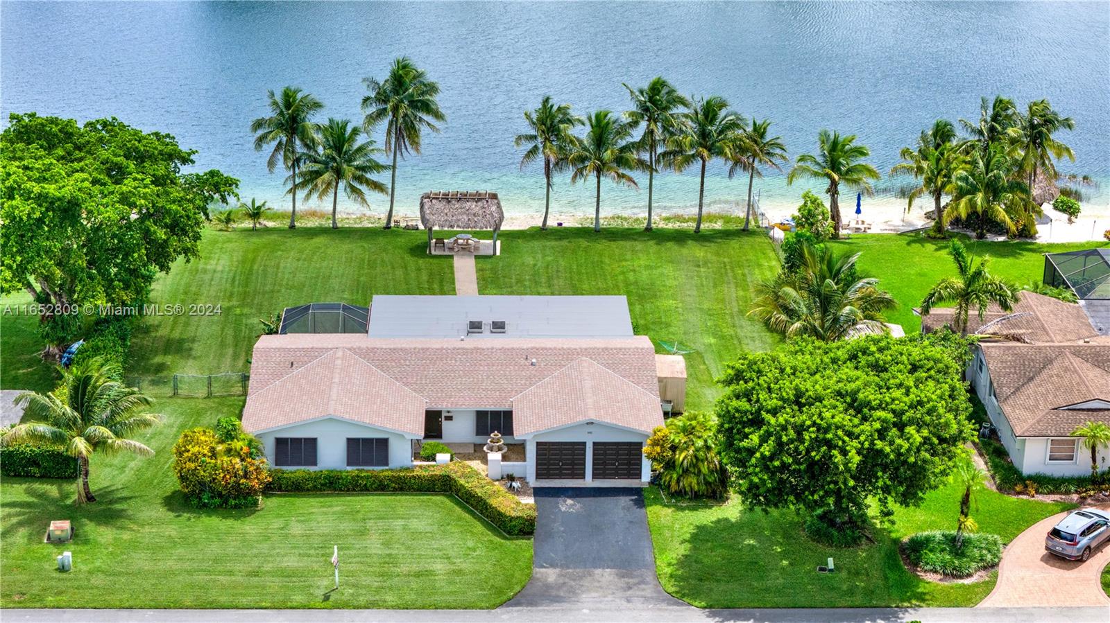 10962 Southwest 117th Street Miami, FL 33176 - Photo 2 of 42 a view of a house with a yard and potted plants