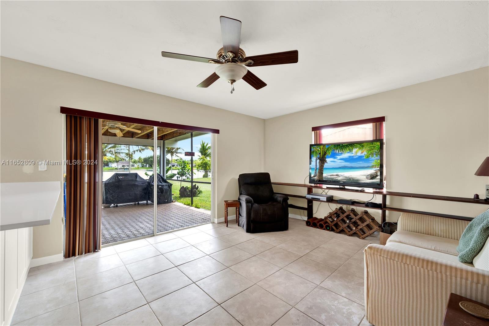 10962 Southwest 117th Street Miami, FL 33176 - Photo 24 of 42 a living room with furniture and a flat screen tv