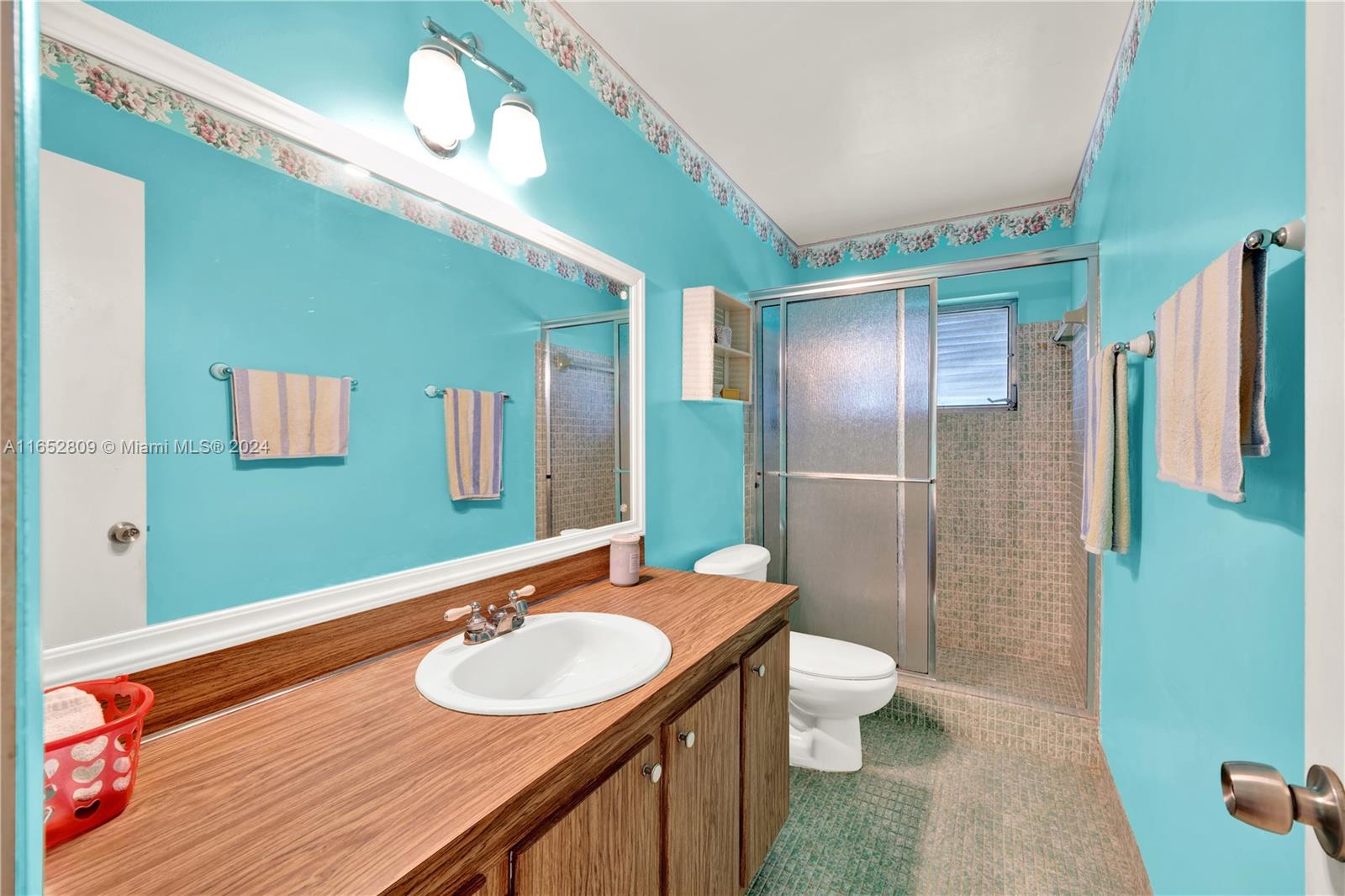 10962 Southwest 117th Street Miami, FL 33176 - Photo 31 of 42 a bathroom with a sink a toilet and shower