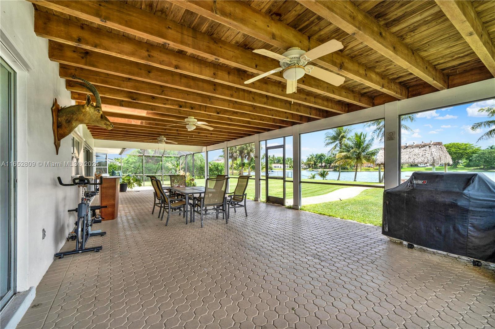 10962 Southwest 117th Street Miami, FL 33176 - Photo 32 of 42 a view of a patio with a table and chairs under an umbrella with a patio