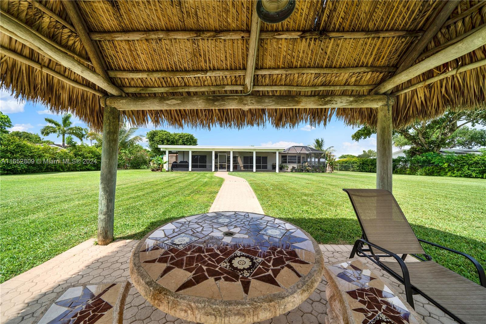 10962 Southwest 117th Street Miami, FL 33176 - Photo 38 of 42 a view of a patio with a table and chairs under an umbrella