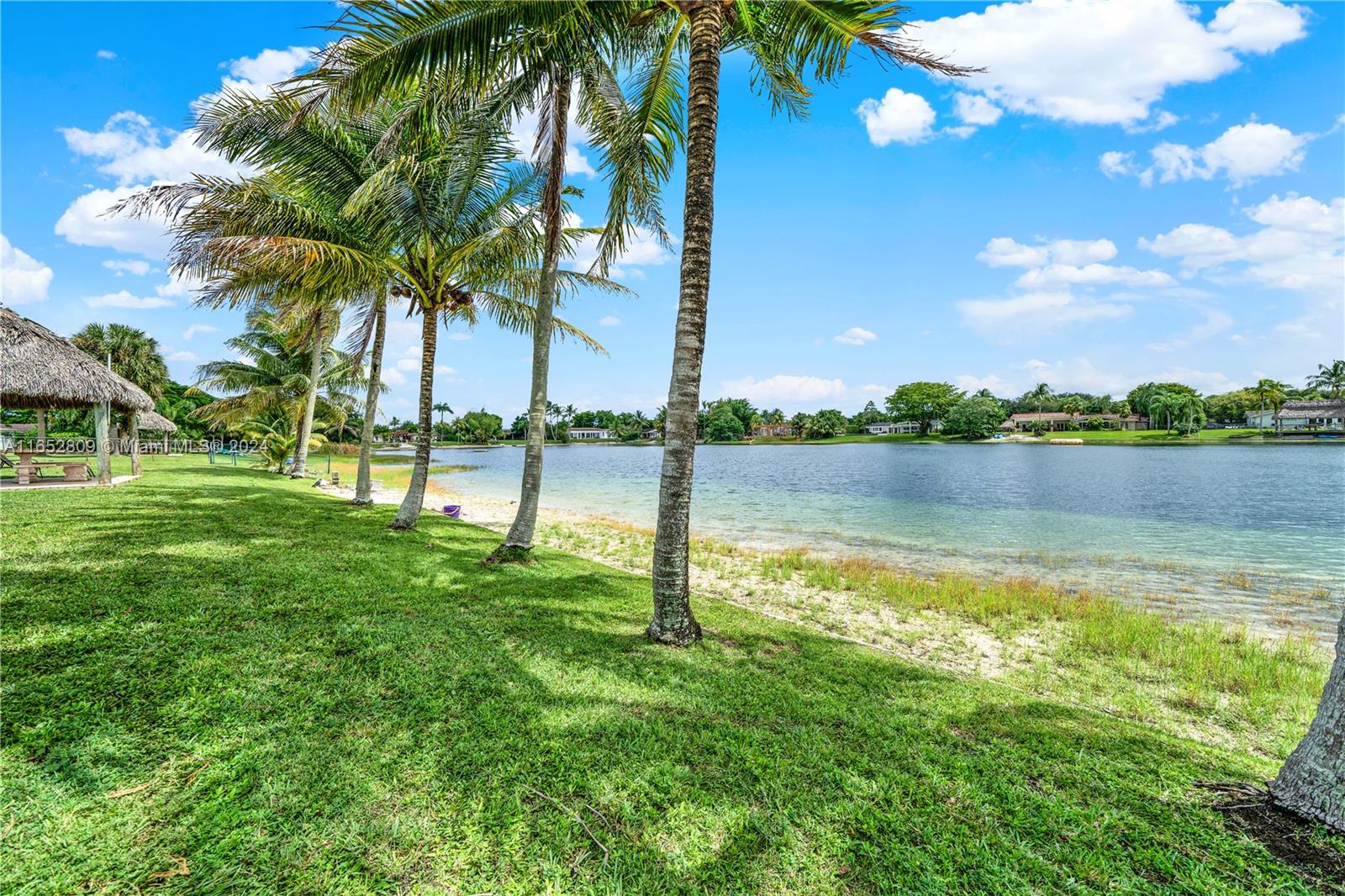 10962 Southwest 117th Street Miami, FL 33176 - Photo 10 of 42 a view of a lake with a big yard and palm trees