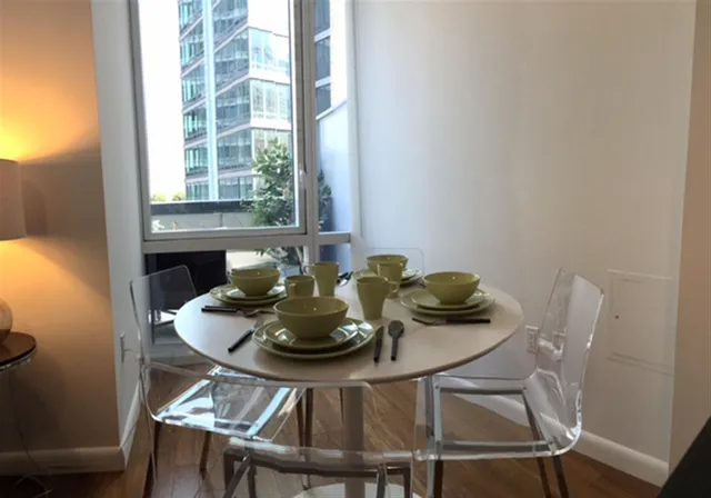 a living room with furniture fireplace and a large window