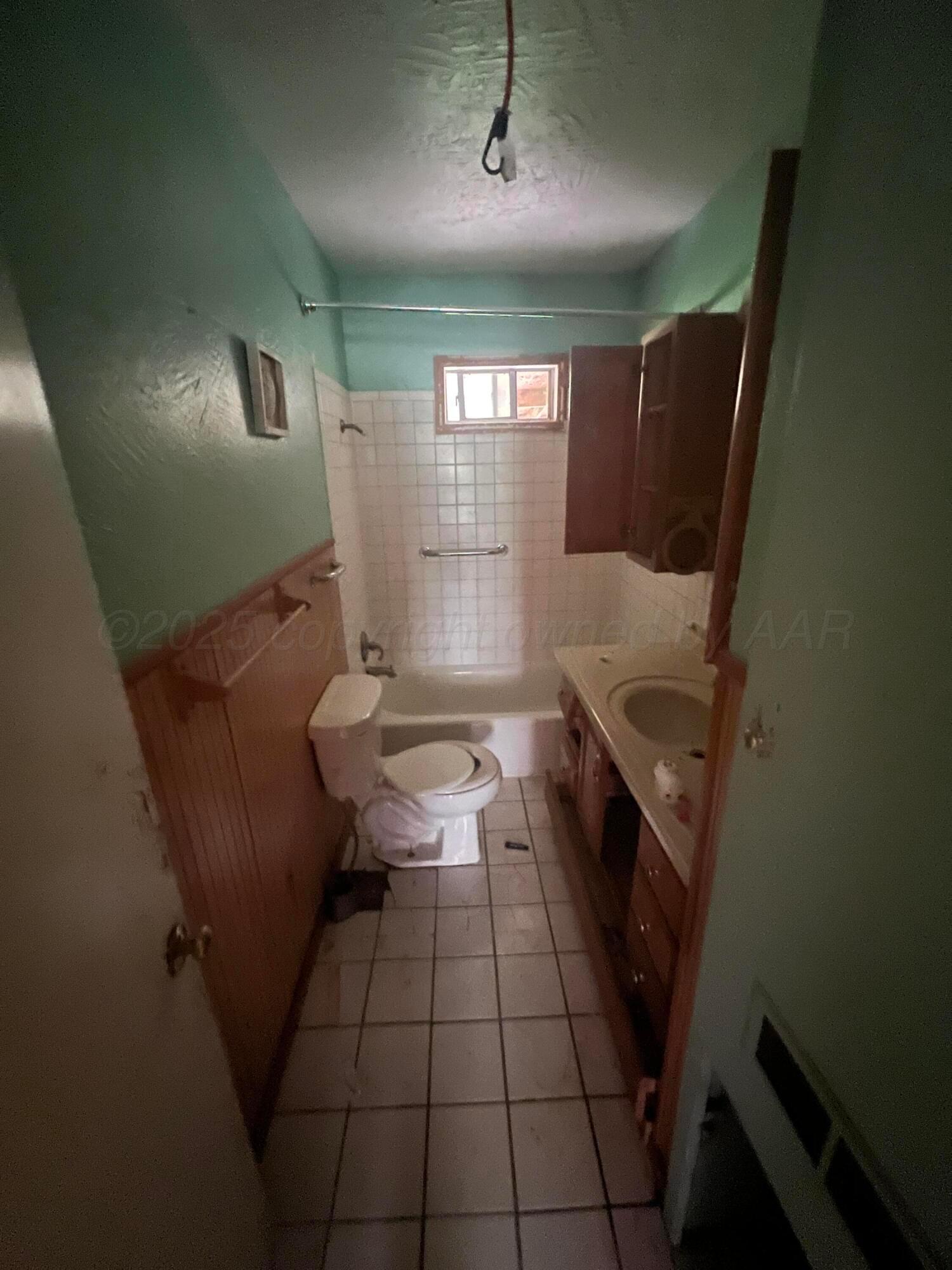 a bathroom with a sink a toilet and tub