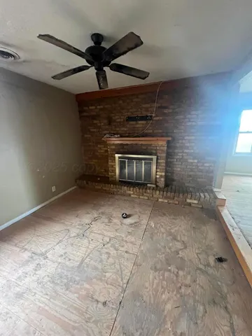 a view of an empty room and fire place