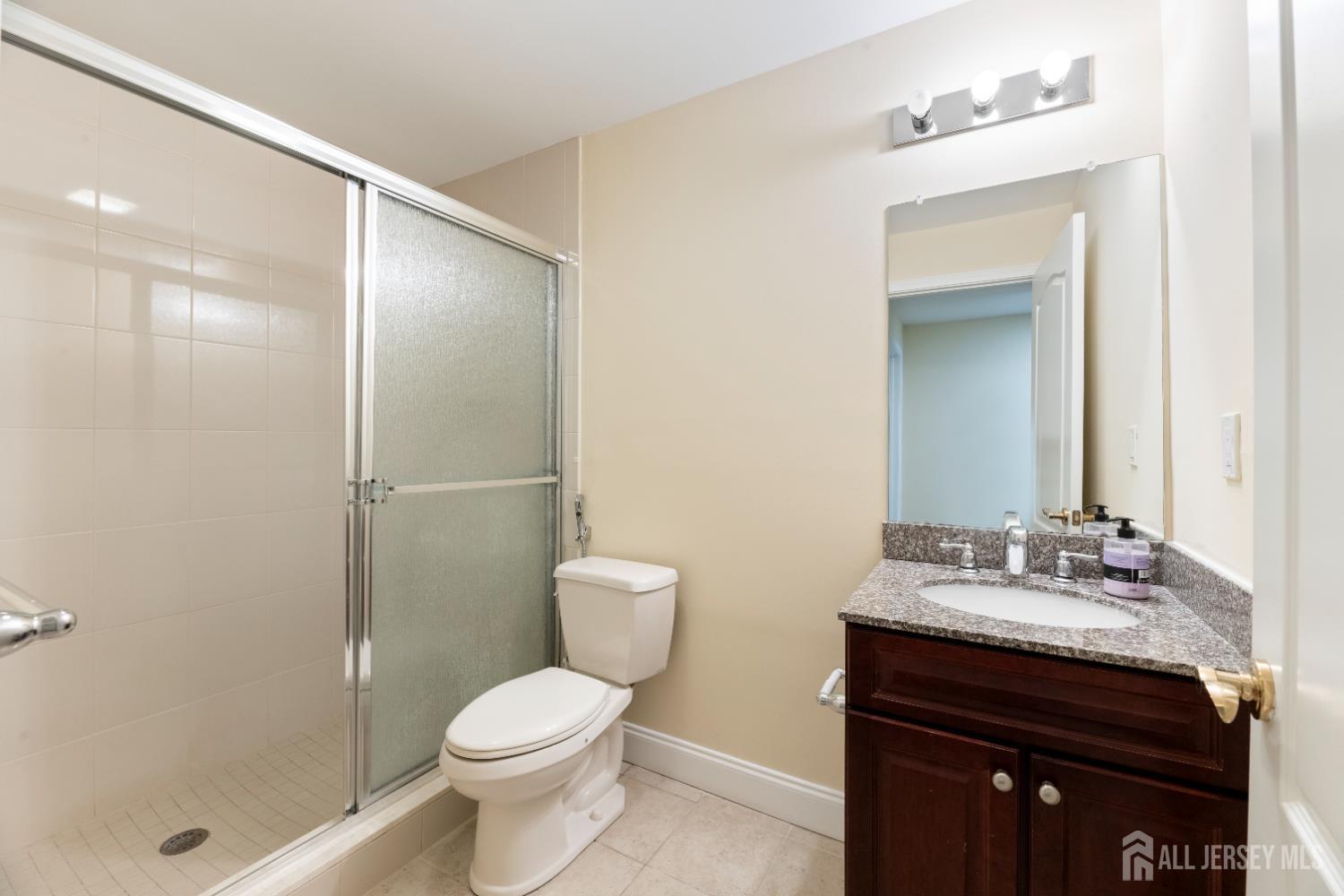 32 Cinder Road, Unit 6 Edison, NJ 08820 - Photo 35 of 47 a bathroom with a sink toilet vanity and shower