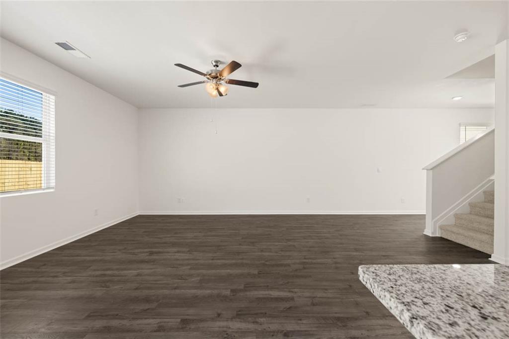 11924 Aukerman Way Hampton, GA 30228 - Photo 21 of 25 a view of a room with wooden floor and a ceiling fan
