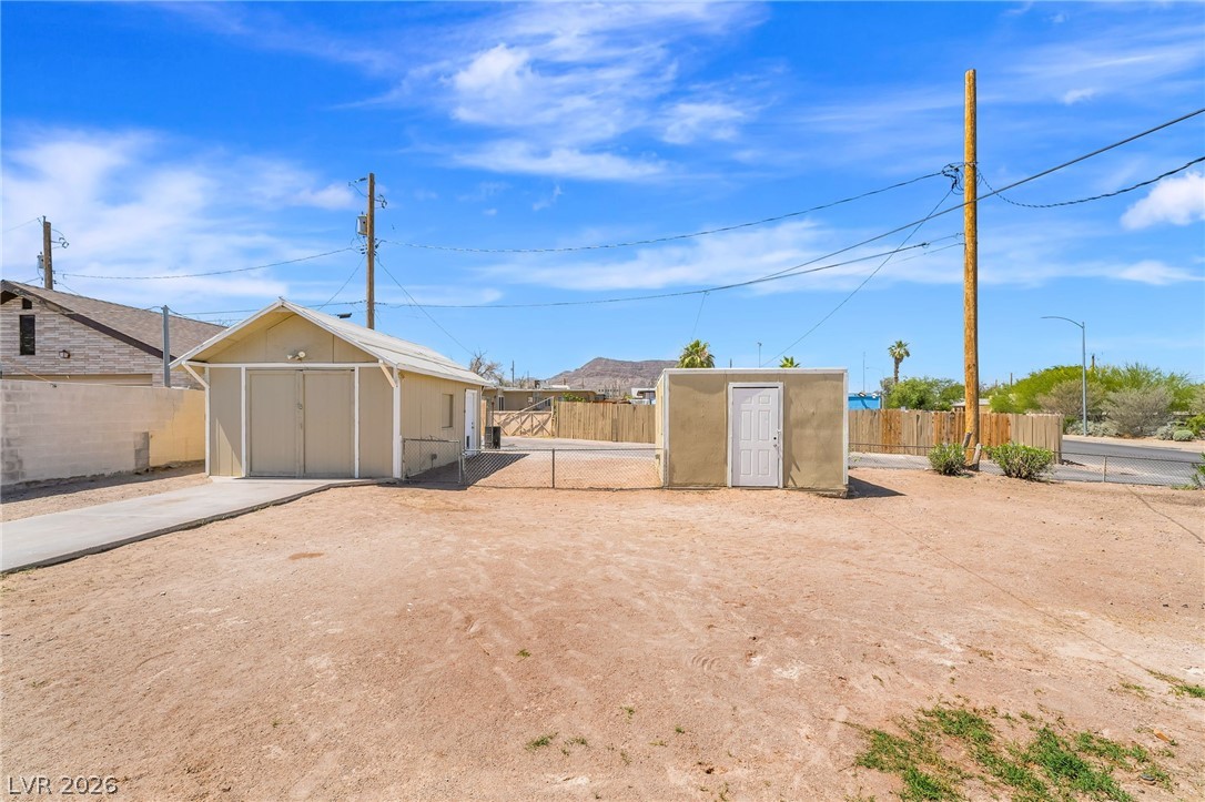2 California Way Henderson, NV 89015 - Photo 24 of 29 A spacious backyard provides ample room for outdoor activities, offering an attached garage and an additional storage shed.