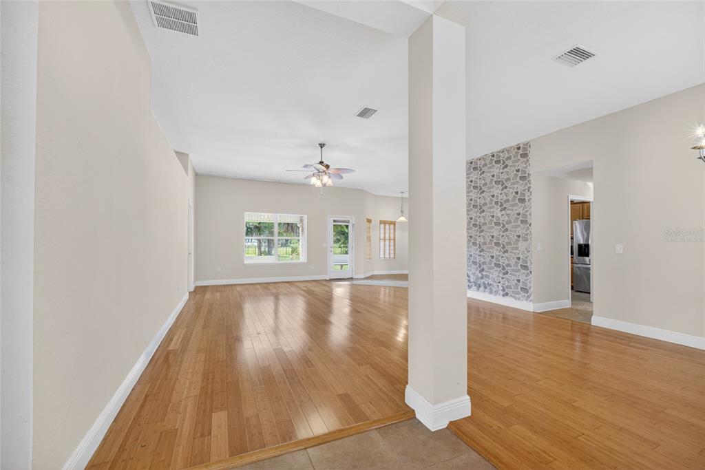 4319 Southwest 63rd Street Ocala, FL 34474 - Photo 4 of 29 a view of an empty room with wooden floor and a window