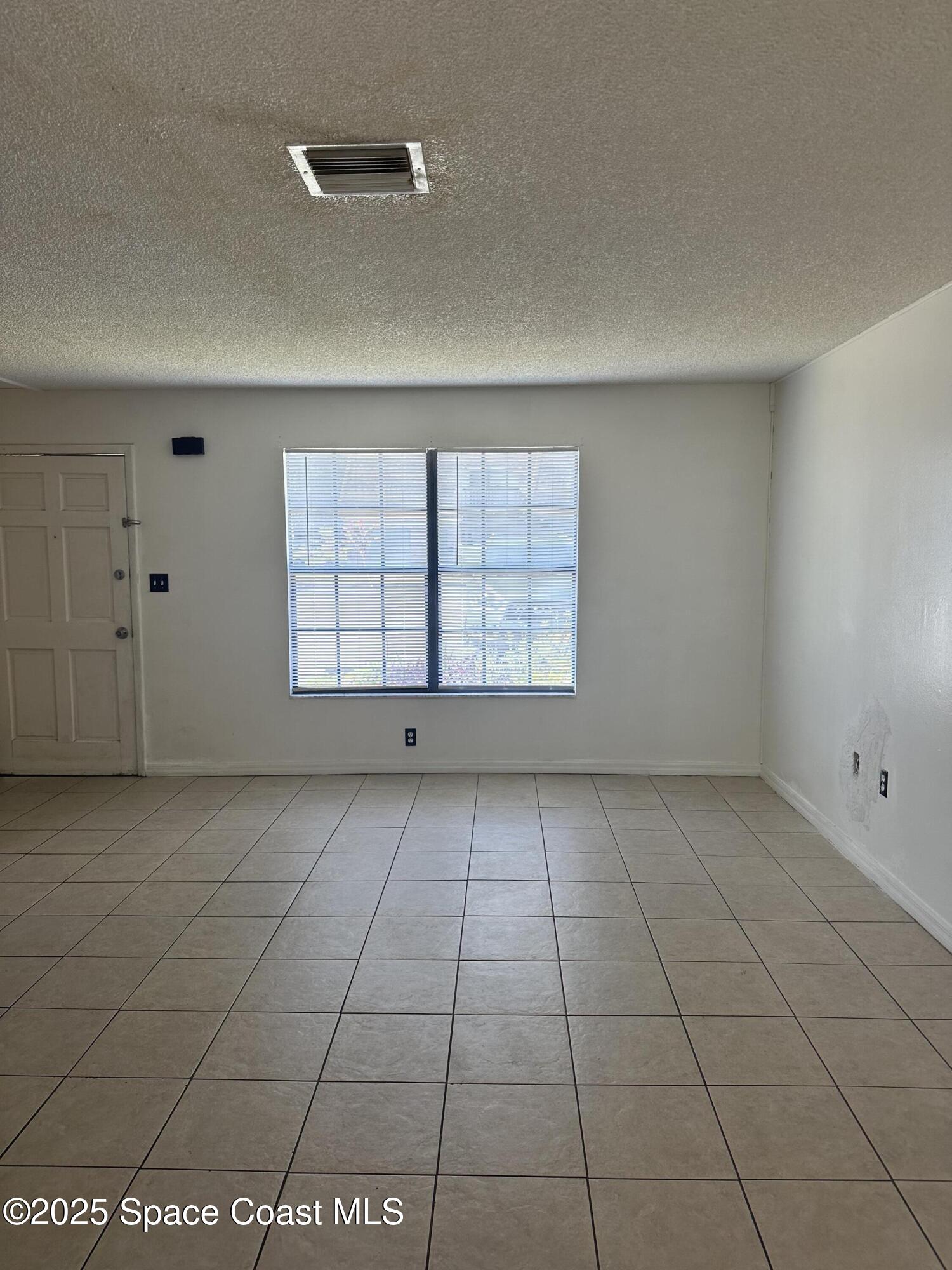 1301 Arlington Lane, Unit 111 Palm Bay, FL 32905 - Photo 4 of 18 an empty room with windows