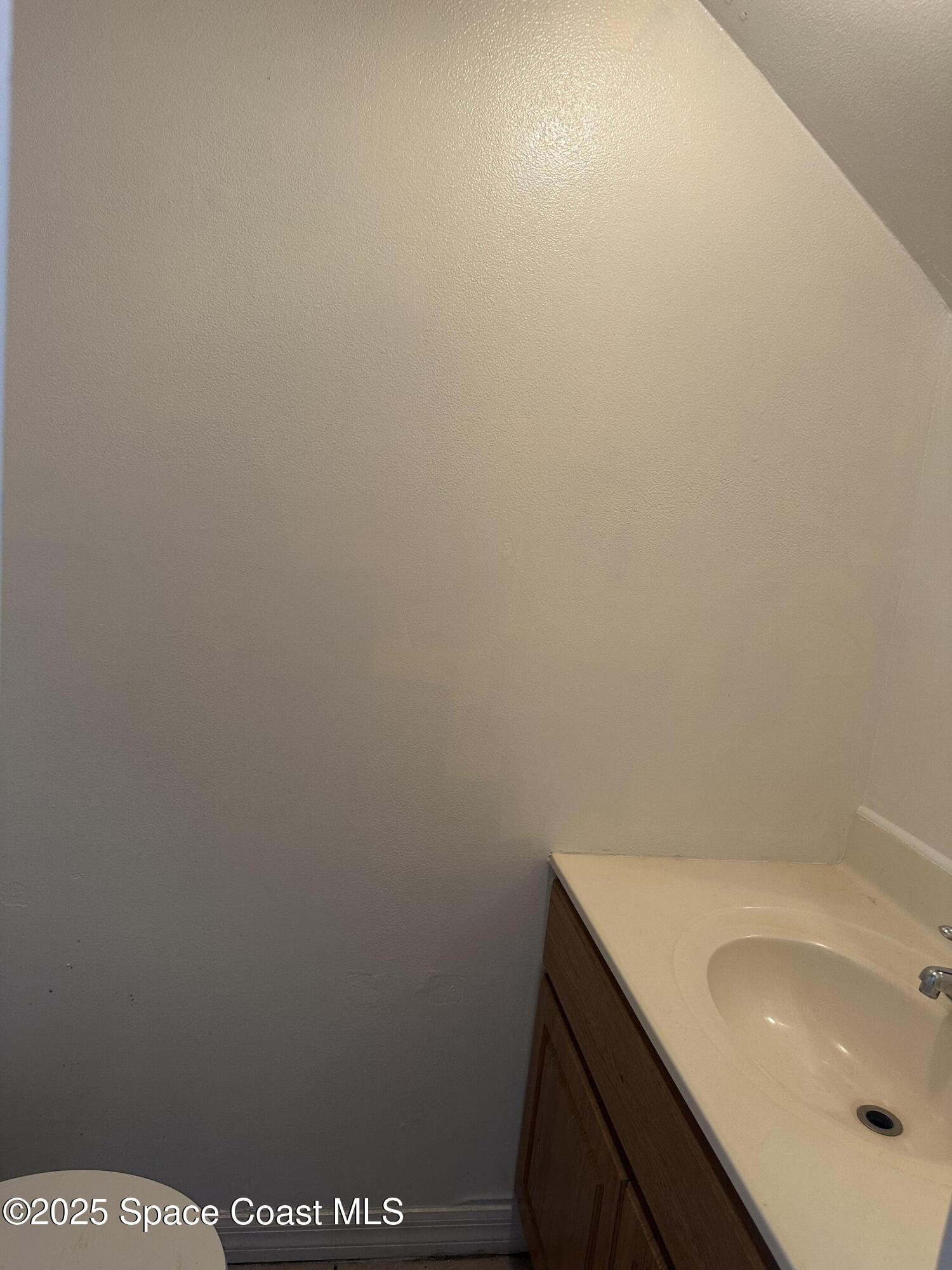 1301 Arlington Lane, Unit 111 Palm Bay, FL 32905 - Photo 5 of 18 a bathroom with a sink and vanity