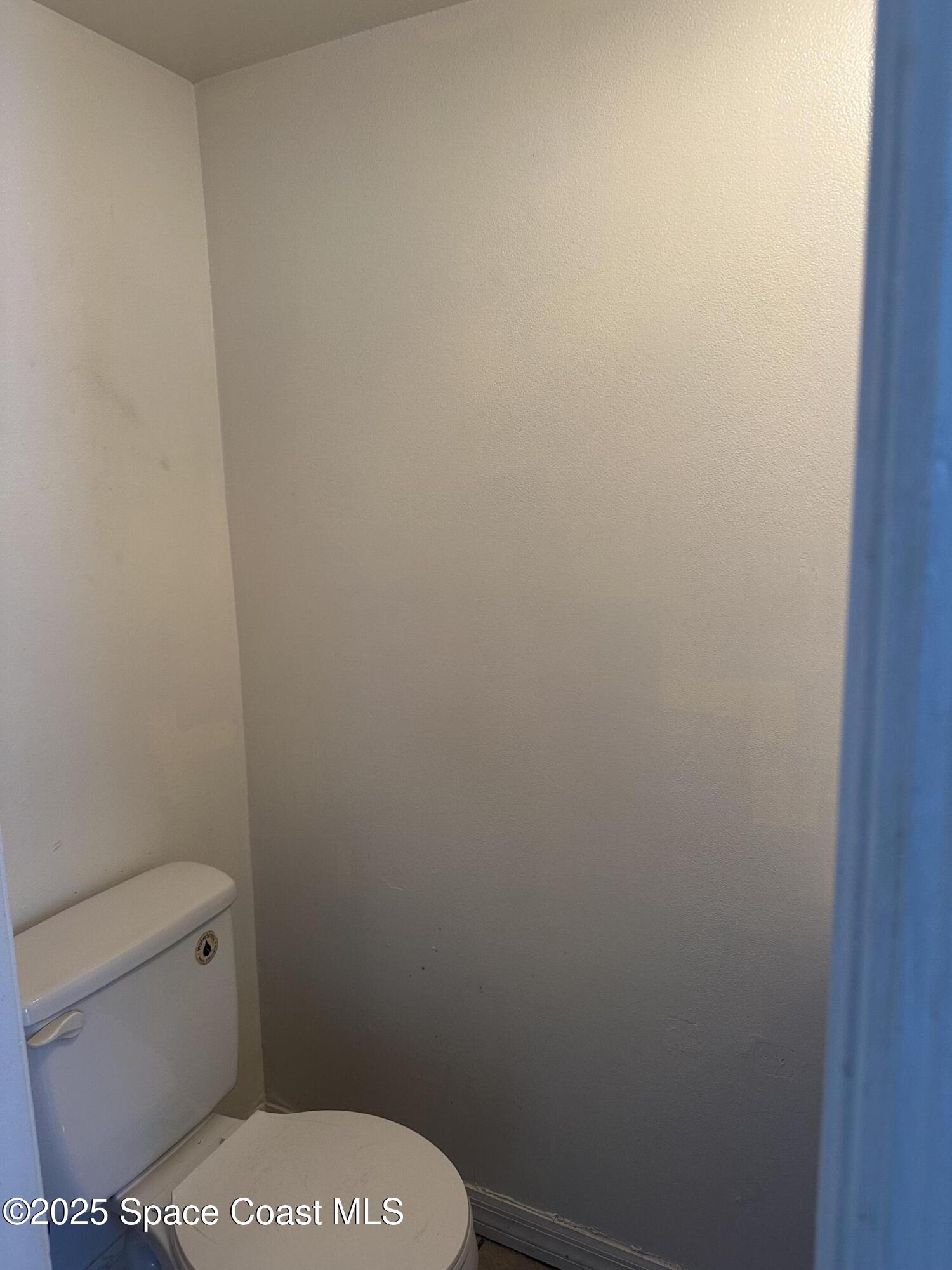 1301 Arlington Lane, Unit 111 Palm Bay, FL 32905 - Photo 6 of 18 a white toilet sitting next to a shower