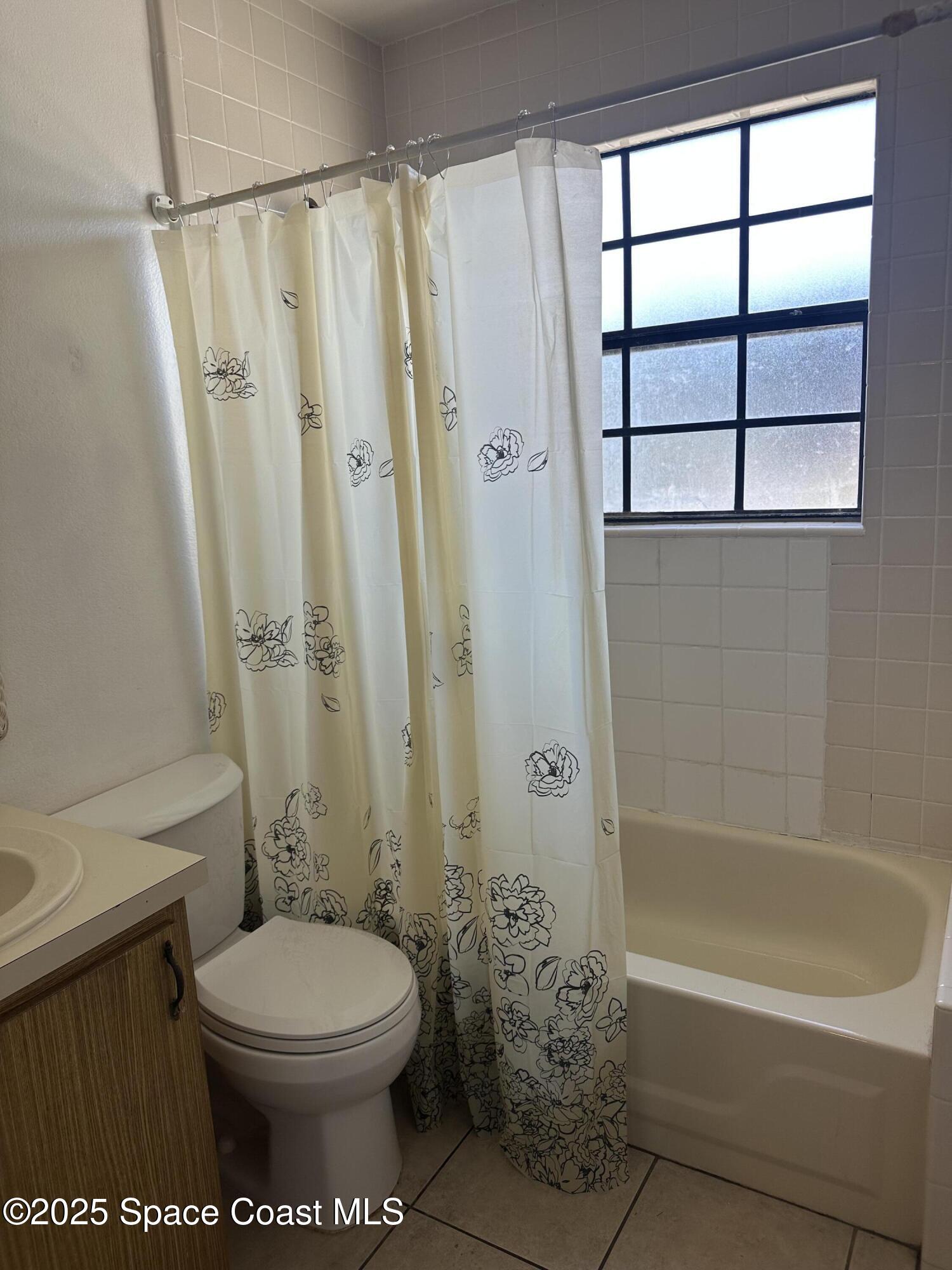 1301 Arlington Lane, Unit 111 Palm Bay, FL 32905 - Photo 9 of 18 a bathroom with a toilet and a shower