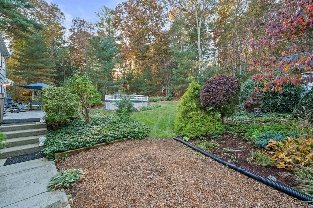 17 Mohawk Road Canton, MA 02021 - Photo 36 of 40 a view of a garden with plants and a bench