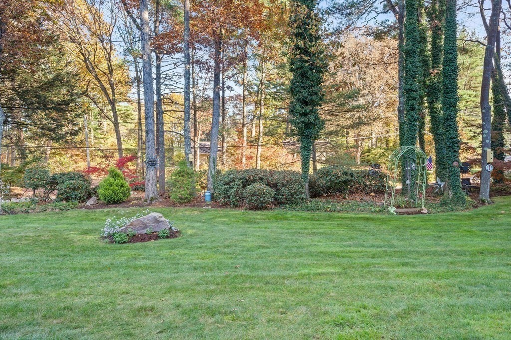 17 Mohawk Road Canton, MA 02021 - Photo 40 of 40 a backyard of a house with lots of green space and fountain