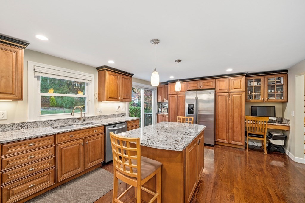 17 Mohawk Road Canton, MA 02021 - Photo 6 of 40 a kitchen with granite countertop kitchen island wooden cabinets and stainless steel appliances