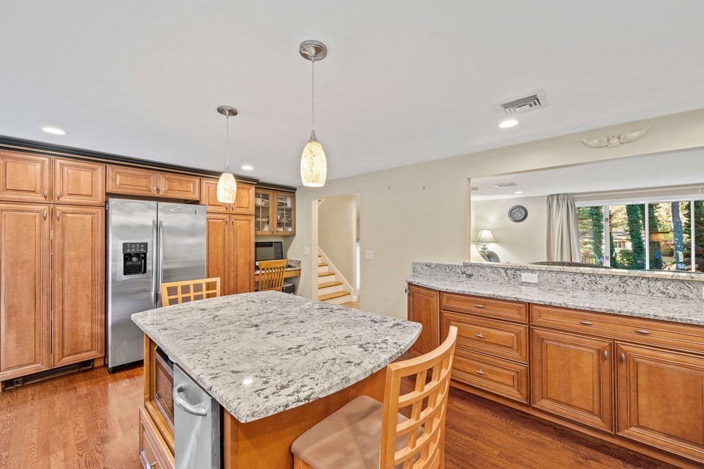 17 Mohawk Road Canton, MA 02021 - Photo 8 of 40 a kitchen with center island table and chairs in it