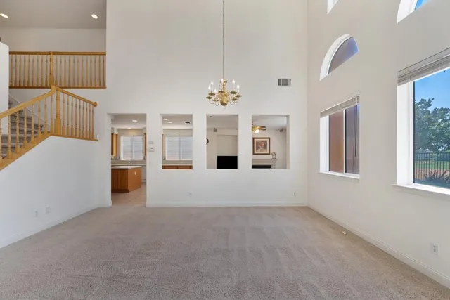 a large kitchen with stainless steel appliances granite countertop a refrigerator and a stove top oven