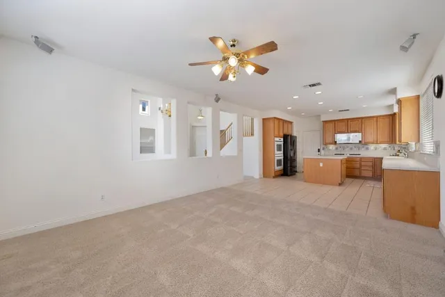 a view of an empty room with window and cabinet