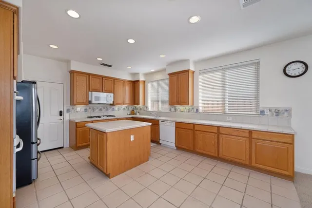 a large kitchen with a sink and cabinets
