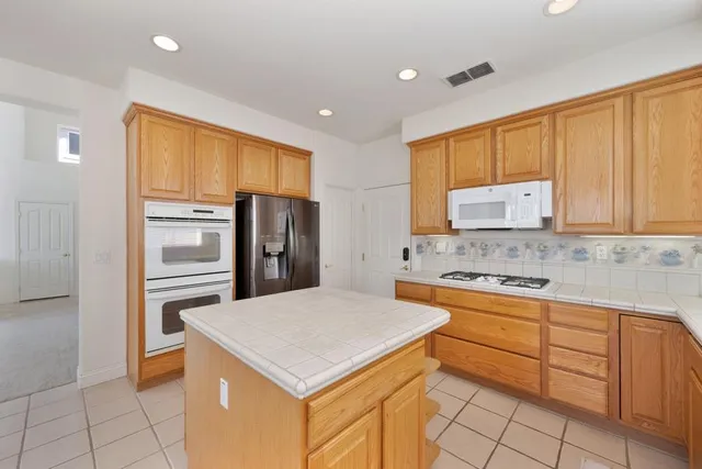 a kitchen with stainless steel appliances a stove a sink and a microwave