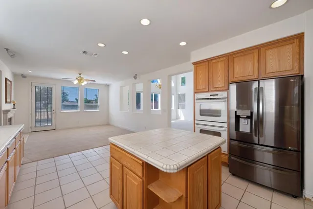a kitchen with stainless steel appliances granite countertop a sink a stove cabinets and a counter space