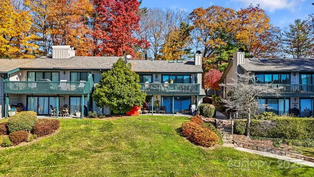 a front view of a house with porch and furniture