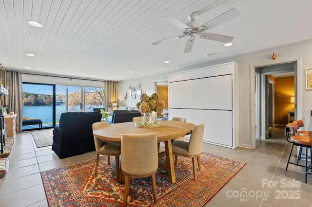 a living room with fireplace furniture and a large window