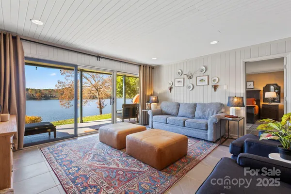 a living room with furniture a fireplace and a rug