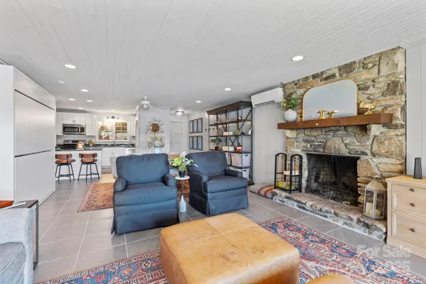 a living room with fireplace furniture and a flat screen tv