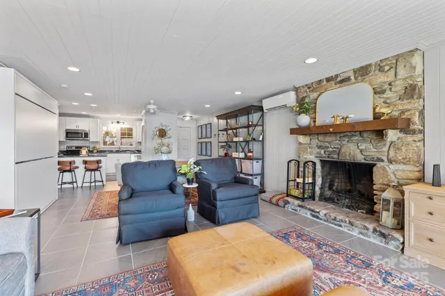 a living room with fireplace furniture and a flat screen tv