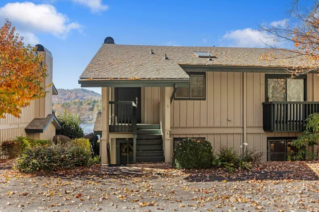 a view of a house with wooden fence