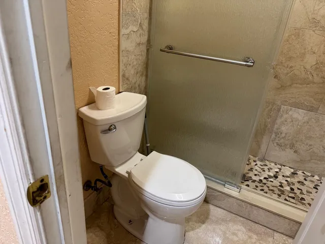 a view of a dining room with furniture and a ceiling fan