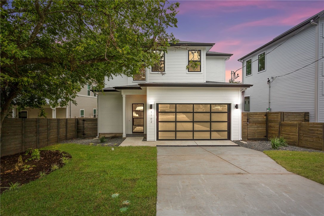 1162 Lott Avenue Austin, TX 78721 - Photo 1 of 1 a front view of a house with a yard and garage