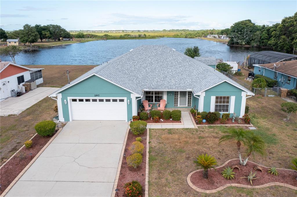 a view of a house with a yard and sitting area