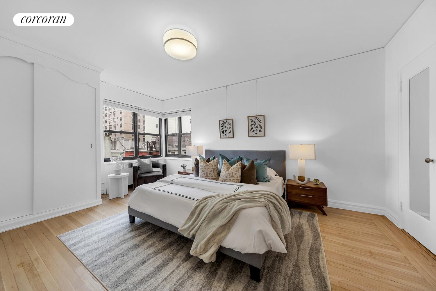 225 East 74th Street, Unit 5A Manhattan, NY 10021 - Photo 4 of 7 a bedroom with a bed and wooden floor