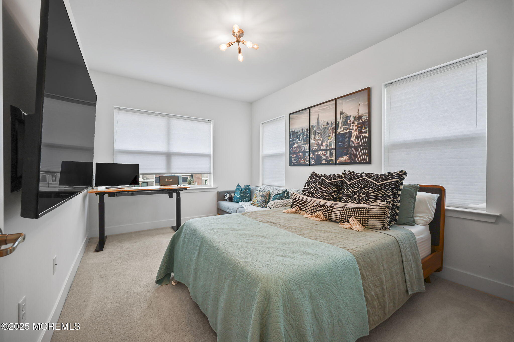 43 Midway Road North Tinton Falls, NJ 07724 - Photo 17 of 20 a large bedroom with a large bed and a chandelier